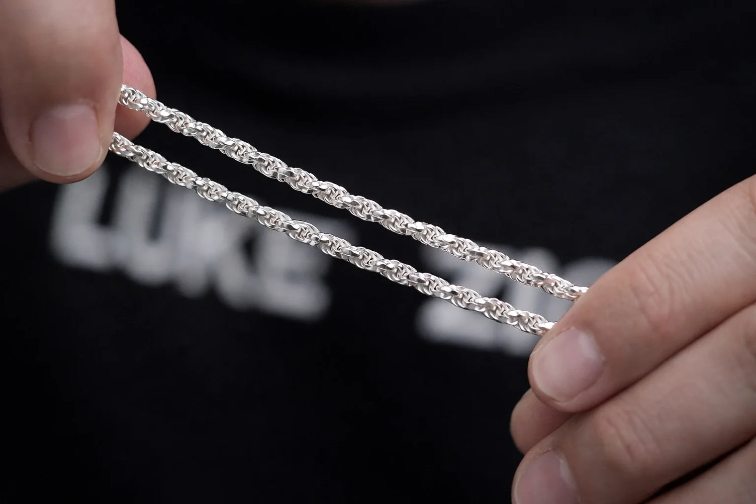 Photo-hands-stretching-thin-rope-chain-making-weave-closeup